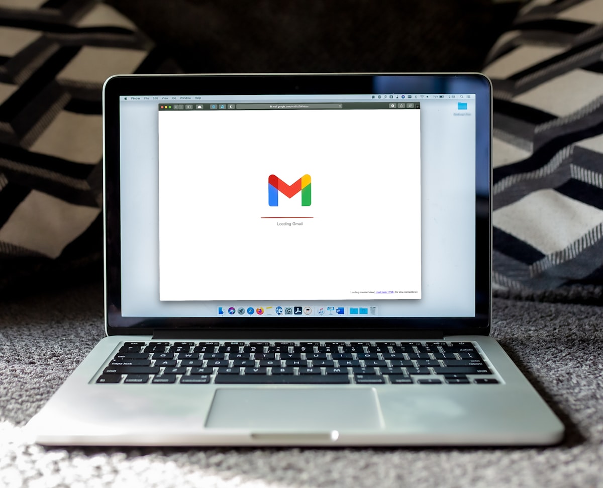 A laptop showing an email client on a desk